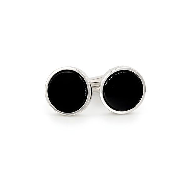 A pair of round silver cufflinks with black onyx. 