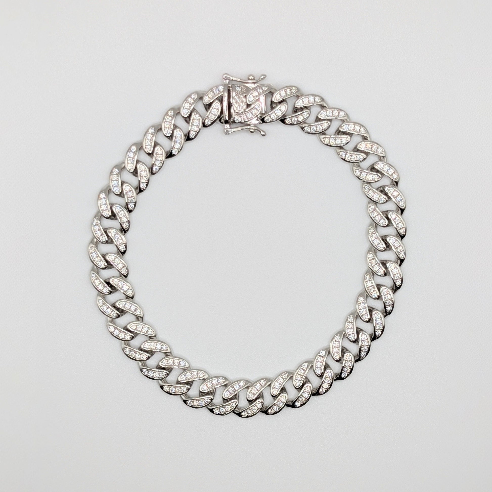 Sterling Silver Iced Curb Cuban Chain Bracelet with brilliant mini Zircon Stones embedded on it.