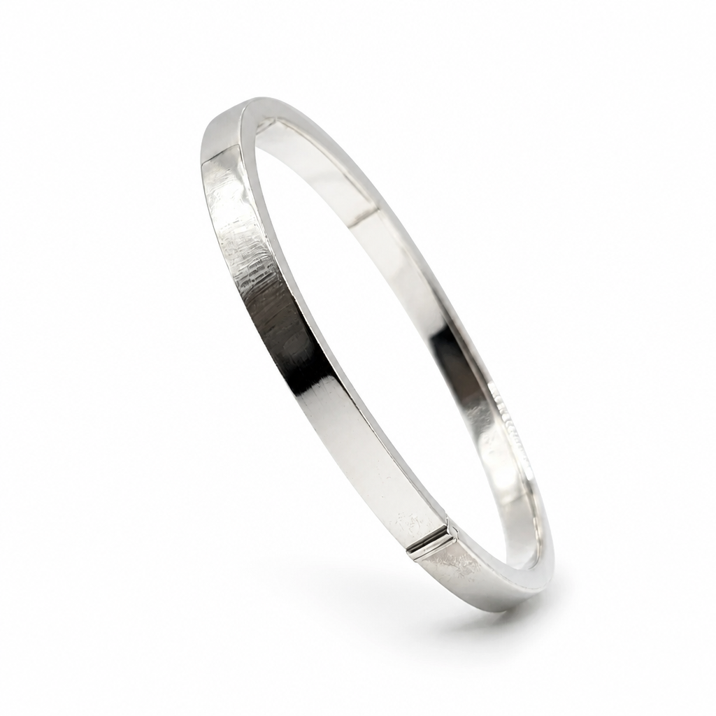 A polished sterling silver bangle bracelet with a flat.
