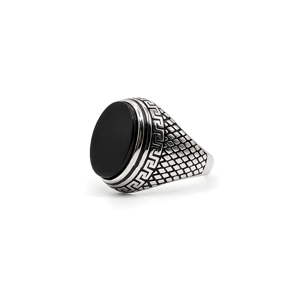 A 925 silver signet ring with a large black onyx and a textured band featuring a Greek key pattern.