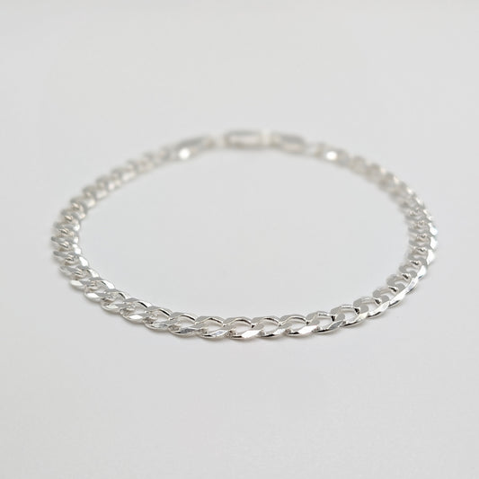 A sterling silver chain bracelet with a curb link design.