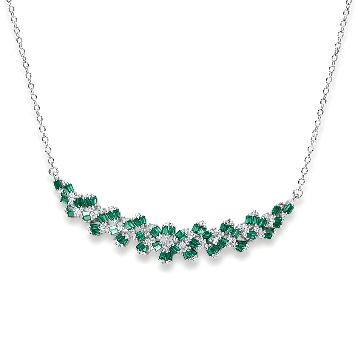 A silver necklace featuring a curved, wavy line of emerald-cut green cubic zirconia and clear stones.