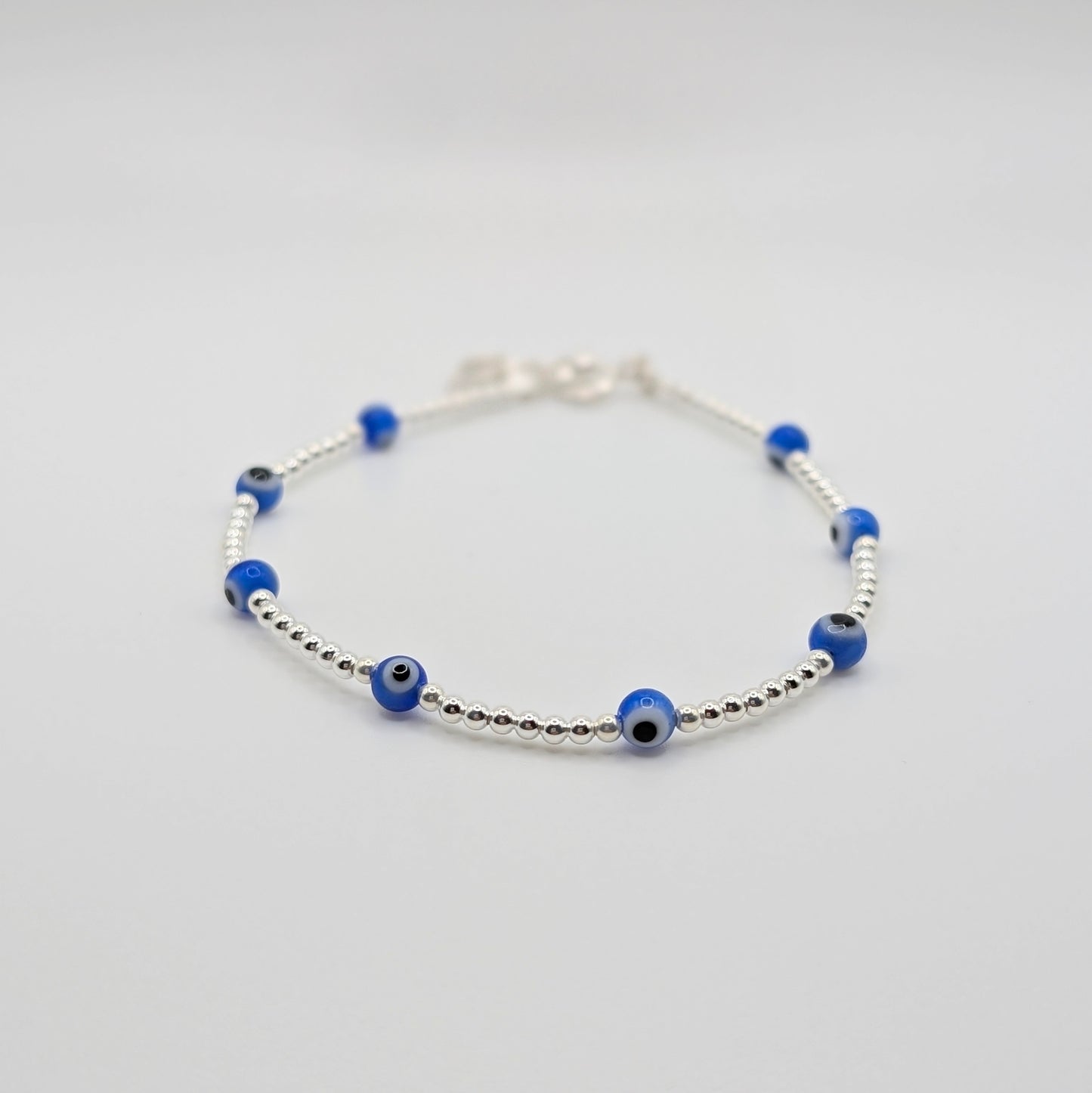 Handmade 925 Sterling Silver Evil Eye Bracelet with silver beads.