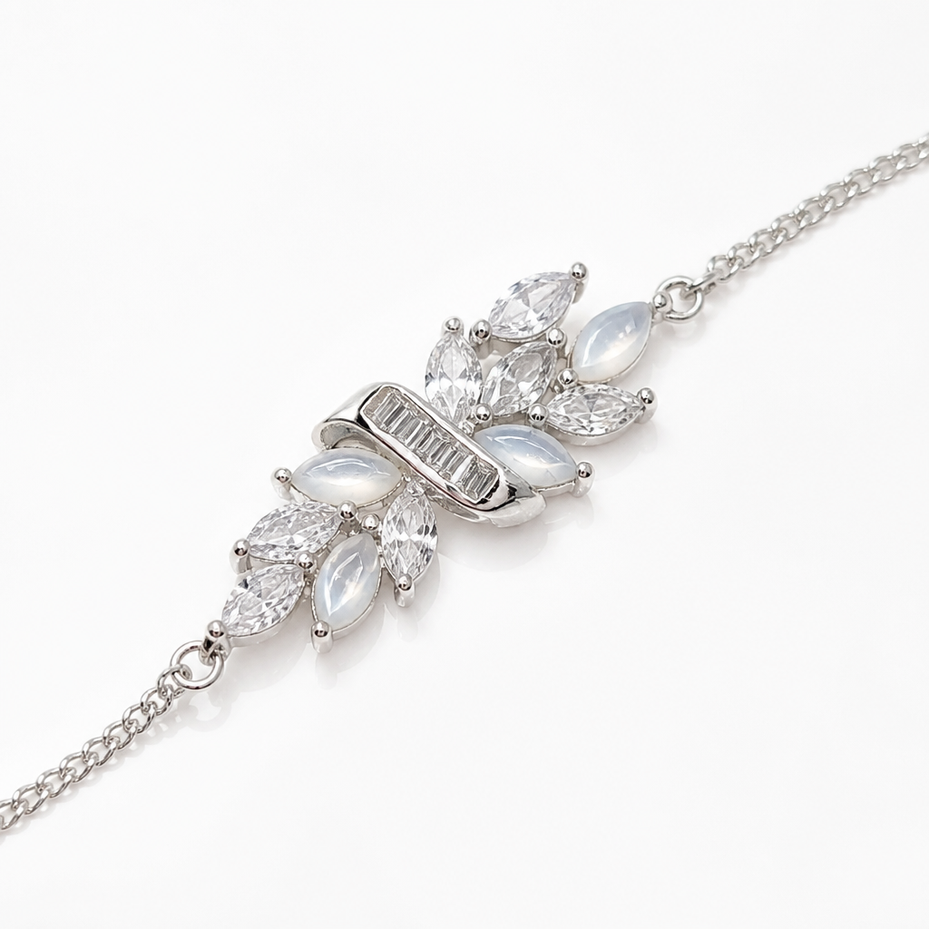 A sterling silver chain bracelet featuring a central butterfly motif adorned with clear marquise-cut crystals and iridescent white opal-like leaves.