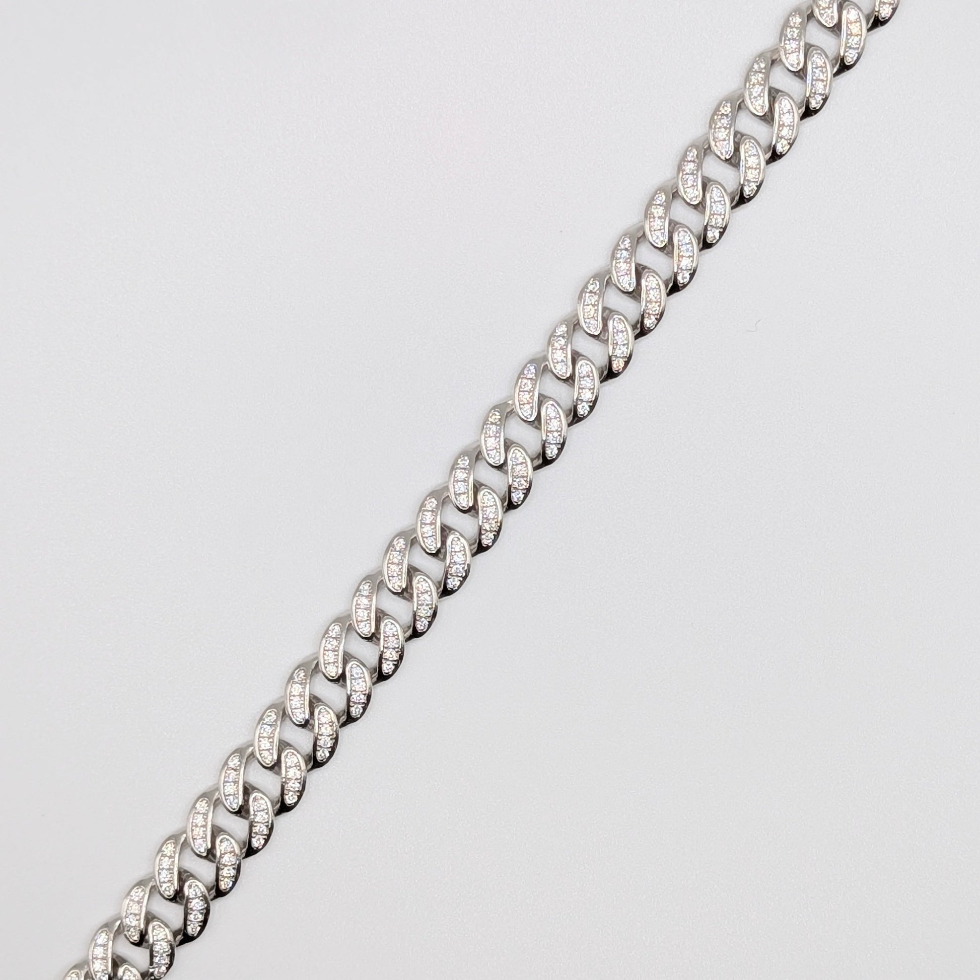 Sterling Silver Iced Curb Cuban Chain Bracelet with brilliant mini Zircon Stones embedded on it.