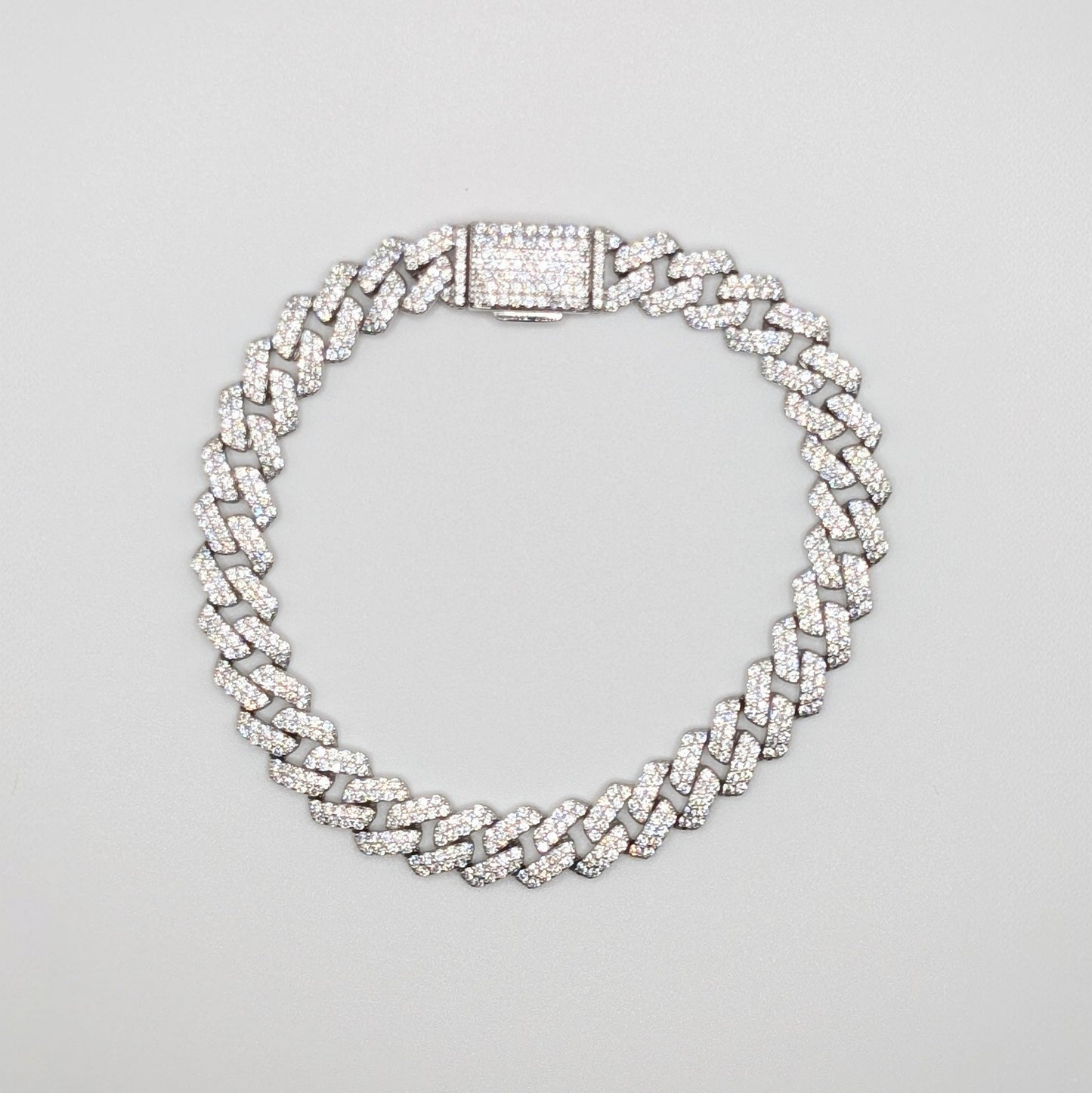 Sterling Silver Iced Curb Cuban Chain Bracelet with brilliant mini Zircon Stones embedded on it.