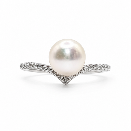 A white freshwater pearl ring set in a silver-colored pavé band.