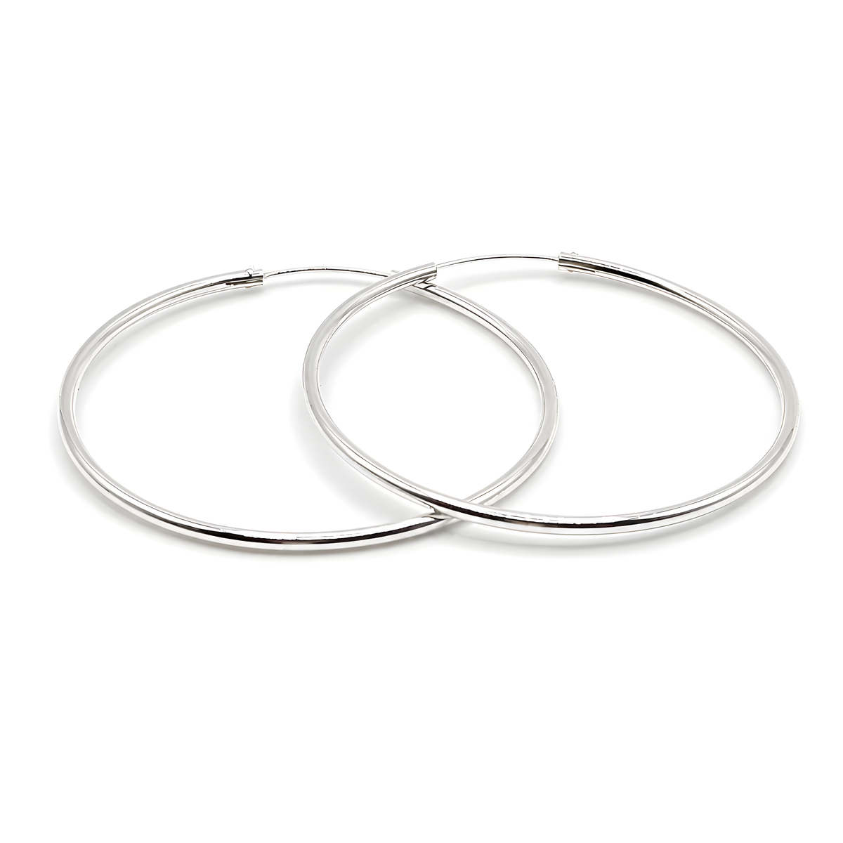 A pair of polished silver hoop earrings.