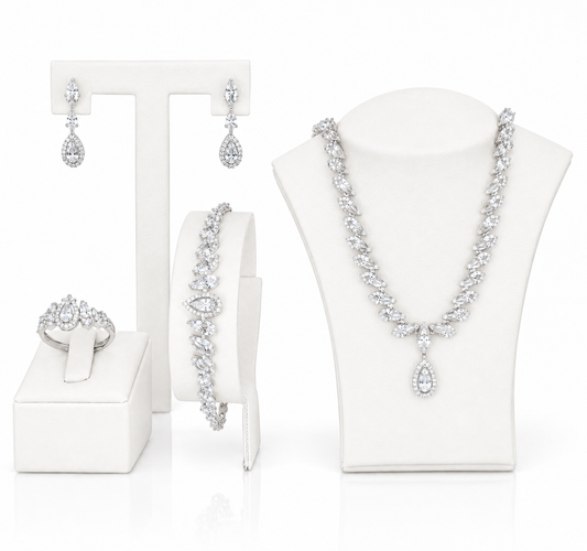 A cubic zircon jewelry set, including a necklace, bracelet, earrings, and ring, all featuring sparkling clear gemstones.