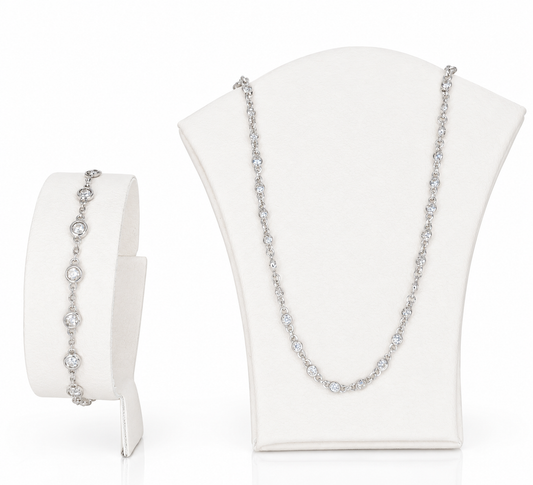 A sterling silver jewellery necklace set, featuring round shaped cubic zirconia in a necklace and bracelet.